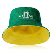 Green and yellow bucket hat with Meriton Suites logo on a white background. Shop Meriton Suites.