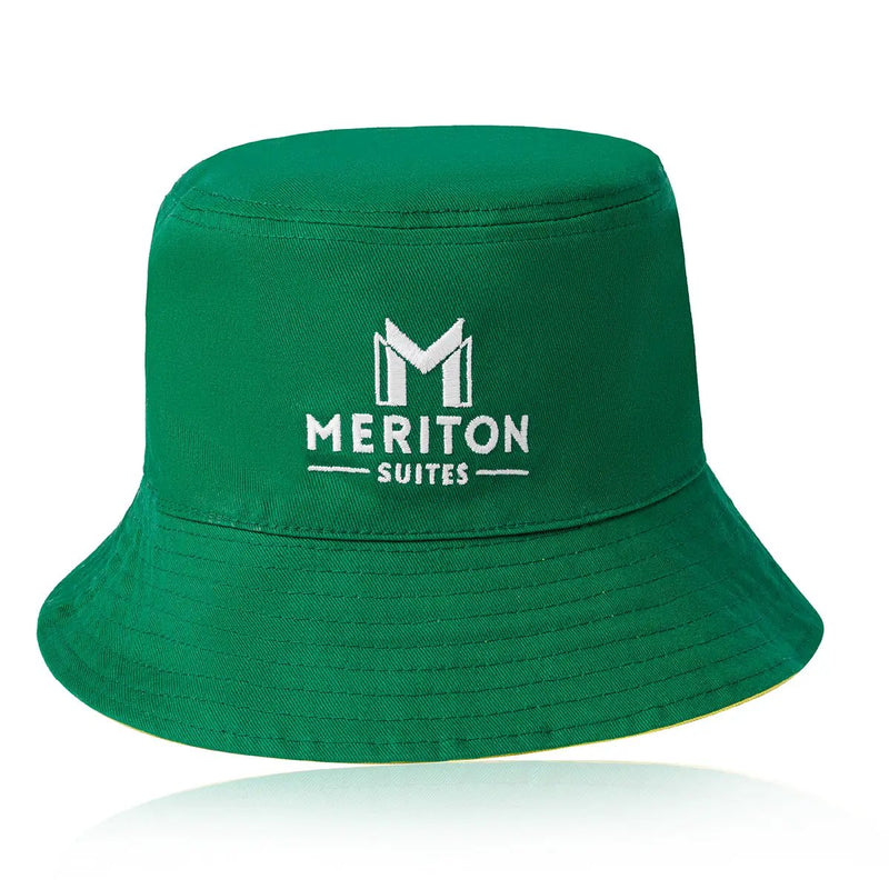 Green bucket hat with Meriton Suites logo on a white background. Shop Meriton Suites.