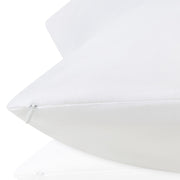 Close-up of a white pillow on a white background.  The Lad Collective bed linen from Shop Meriton Suites.