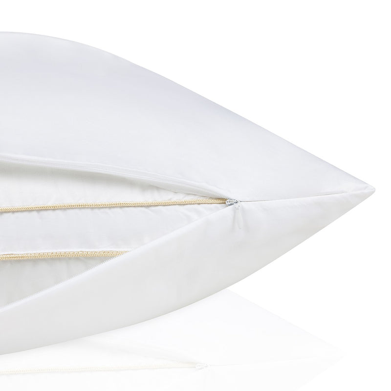 Close-up of a white pillow with a gold accent on a white background.  The Lad Collective bed linen from Shop Meriton Suites.