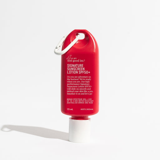 Red sunscreen lotion bottle with carabiner on a white background. Shop Meriton Suites. We are feel good inc. spf sunscreen.