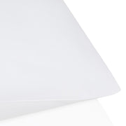 White lampshade on a white background.  The Lad Collective bed linen from Shop Meriton Suites.