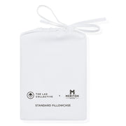 White pillowcase with 'The Lad Collective' and 'Meriton Suites' logos on a white background.  The Lad Collective bed linen from Shop Meriton Suites.