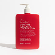 A 400ml red pump bottle of 'we are feel good inc.' Signature Sunscreen Lotion SPF 50+ on a clean white background. Shop Meriton Suites. We are feel good inc. spf sunscreen.