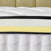 Close-up of a mattress with visible layers including a yellow foam layer.