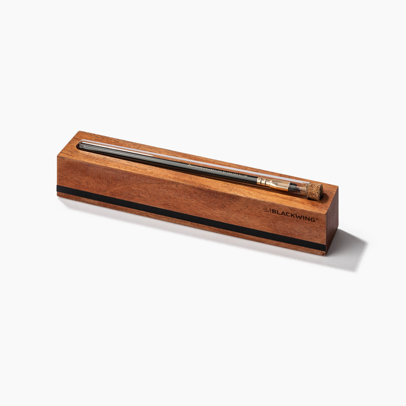 Wooden pencil holder with a pen inside on a white background